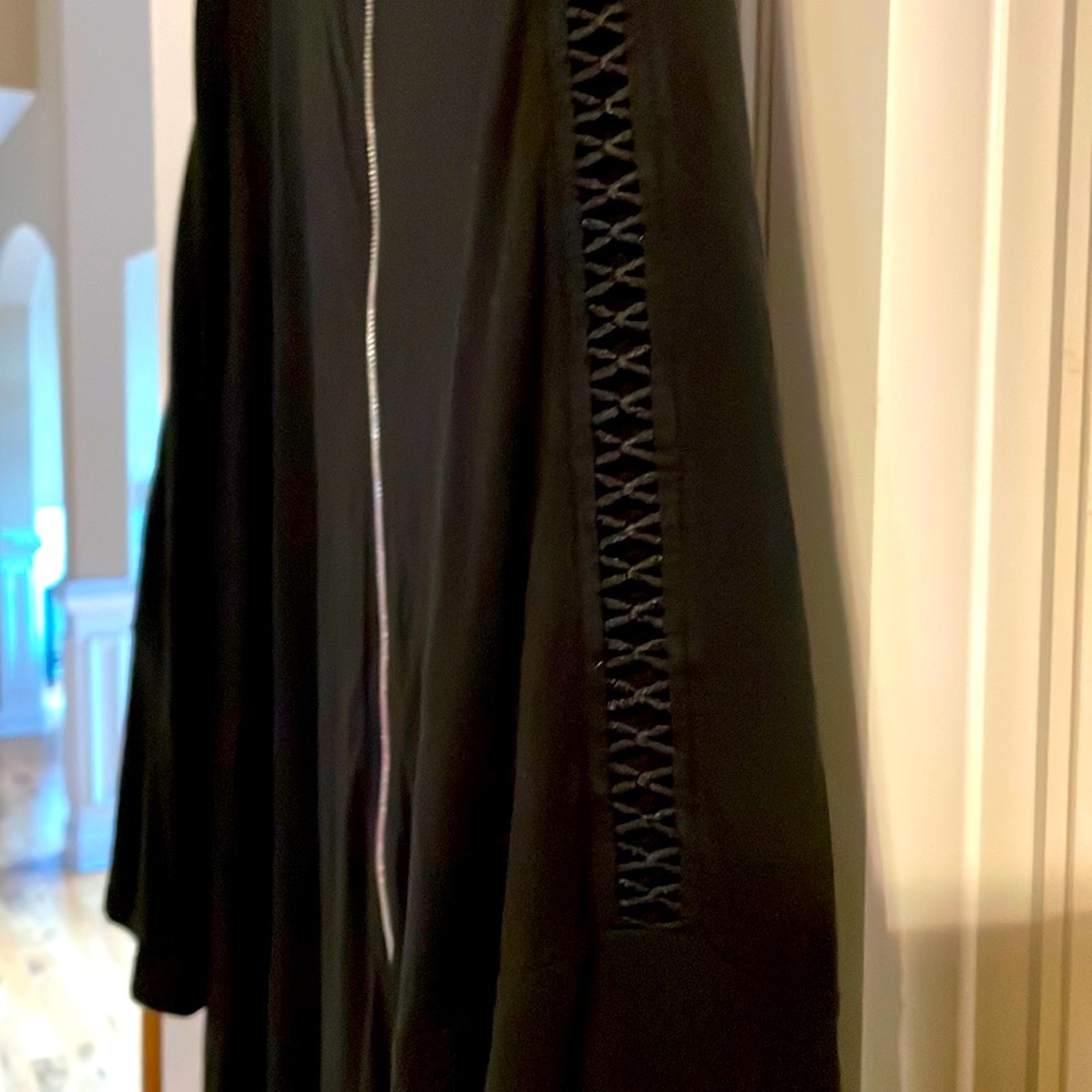 Black dress above the knee, some flare, silver zipper cutout detail on sleeves